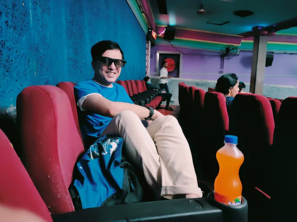 Sumit Guha sitting in a Movie Theatre during Interval